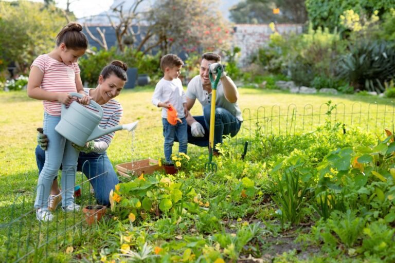 happy-caucasian-family-gardening-and-watering-plants-together